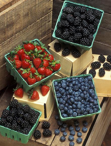 Containers of blackberries, blueberries, and strawberries.