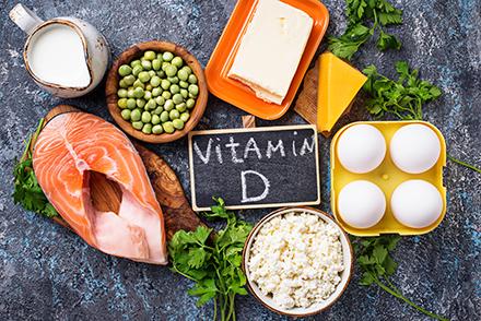 Eggs, rice, cheese, salmon and a chalkboard sign saying Vitamin D