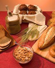 Bran muffins, brown rice, a loaf of whole-wheat bread, whole-wheat bagels, and whole-grain cereal.